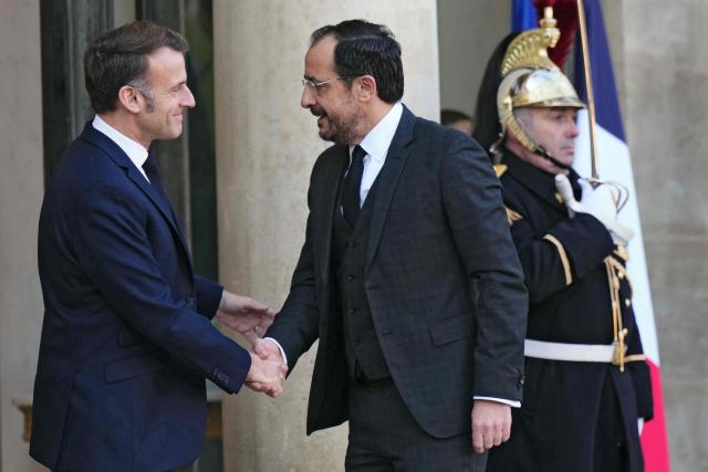 France's President Emmanuel Macron (L) greets Cyprus' President Nikos Christodoulides prior to their meeting at the Elysee Palace in Paris, on December 15, 2025. (Photo by Dimitar DILKOFF / AFP)