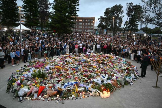 Mourners gather at a tribute at the Bondi Pavillion in memory of the victims of a shooting at Bondi Beach, in Sydney on December 15, 2025. A father and son opened fire on a Jewish festival at Australia's Bondi Beach in a shooting spree that killed 15 people, including a child, authorities said on December 15, denouncing the attack as antisemitic "terrorism". (Photo by Saeed KHAN / AFP)