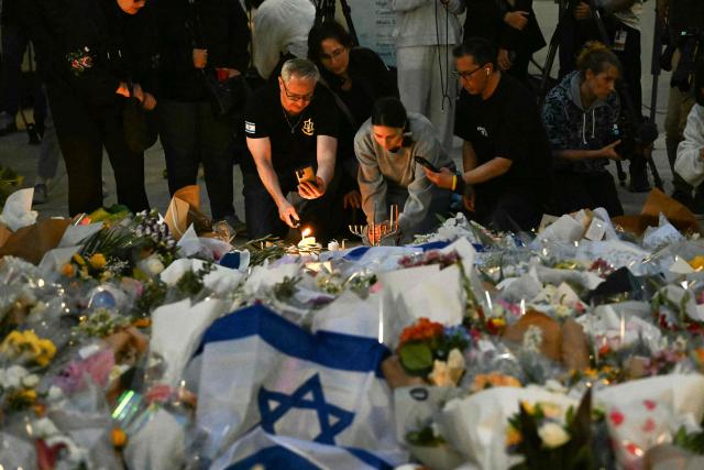 Mourners gather at a tribute at the Bondi Pavillion in memory of the victims of a shooting at Bondi Beach, in Sydney on December 15, 2025. A father and son opened fire on a Jewish festival at Australia's Bondi Beach in a shooting spree that killed 15 people, including a child, authorities said on December 15, denouncing the attack as antisemitic "terrorism". (Photo by Saeed KHAN / AFP)