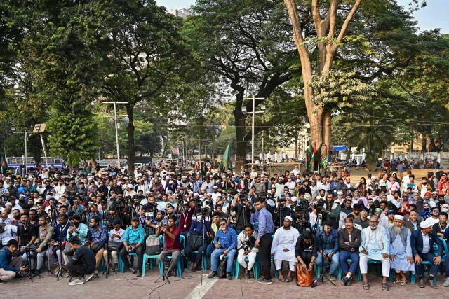 Activists stage a demonstration in Dhaka on December 15, 2025 to condemn an attack on Sharif Osman Hadi, senior leader of the student protest group Inqilab Mancha who was shot outside a mosque. Bangladesh's interim government said it would fly a leader of the 2024 student-led uprising, a candidate in upcoming elections, for treatment in Singapore after an assassination attempt on December 12 that left him critically wounded. (Photo by Munir UZ ZAMAN / AFP)