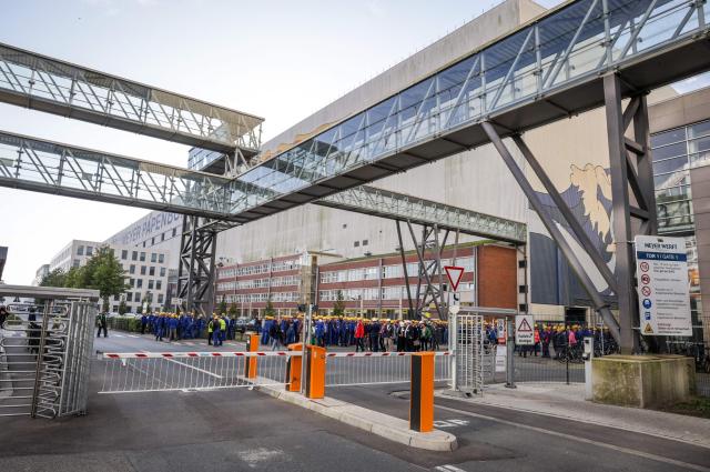 (FILES) Workers are seen at he main gate after a company meeting at the Meyer shipyards in Papenburg, northwestern Germany on September 16, 2024. The partially state-owned Meyer Werft shipyard in Lower Saxony has received a billion-euro order from the Swiss shipping company MSC. The two companies have just signed a corresponding contract “that secures the future of Meyer Werft,” said German Economy Minister Katherina Reiche on December 15, 2025. According to the ministry, it involves four to six ships with an order value of ten billion euros. (Photo by Focke STRANGMANN / AFP)