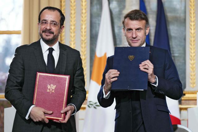 France's President Emmanuel Macron (R) and Cyprus' President Nikos Christodoulides pose during a document signing ceremony following their meeting at the Elysee Palace in Paris, on December 15, 2025. (Photo by Dimitar DILKOFF / AFP)