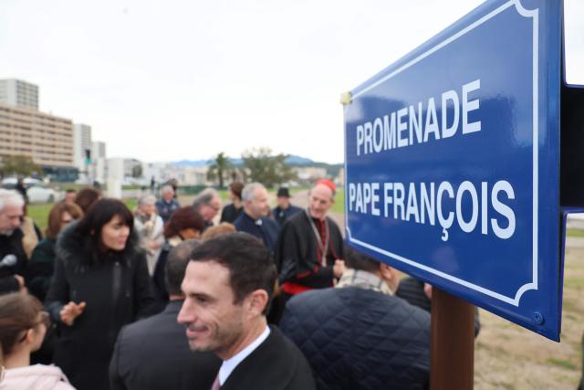 A picture taken on December 15, 2025 shows the Promenade Pape François street sign after its inauguration on December 15, 2025 in commemoration of the visit of Pope Francois in Ajaccio on the Corsican island of Corsica one year ago. (Photo by Pascal POCHARD-CASABIANCA / AFP)