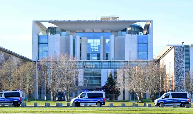 Police cars are seen in front of the Chancellery in Berlin, Germany, on December 15, 2025, where talks are held between the Ukrainian President and representatives of the US government. European leaders as well as the Ukrainian President, US President Donald Trump's envoy, and heads of the NATO meet in the German capital for talks on how to end the grinding war of Russia with Ukraine. (Photo by John MACDOUGALL / AFP)