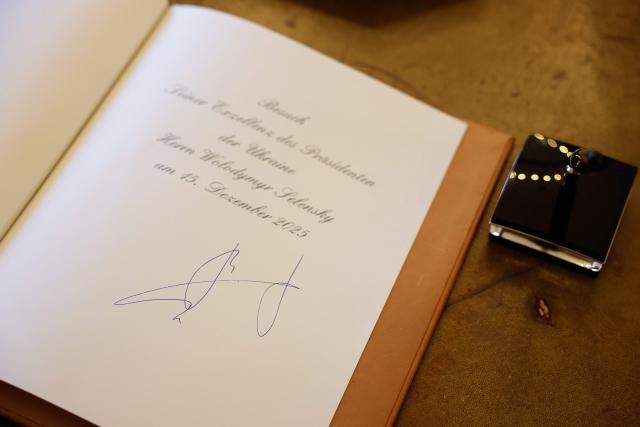 View of the guestbook after it was signed by Ukraine's President prior talks with Germany's President at the presidential Bellevue Palace in Berlin, Germany, on December 15, 2025. Ukrainian President Volodymyr Zelensky was set to push on with talks in Berlin with US President Donald Trump's envoys on how to end the grinding war with Russia. (Photo by Odd ANDERSEN / AFP)