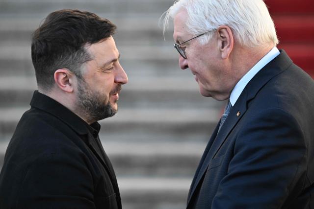 German President Frank-Walter Steinmeier (R) welcomes Ukraine's President Volodymyr Zelensky at the presidential Bellevue Palace in Berlin, Germany, on December 15, 2025. Ukrainian President Volodymyr Zelensky was set to push on with talks in Berlin with US President Donald Trump's envoys on how to end the grinding war with Russia. (Photo by RALF HIRSCHBERGER / AFP)