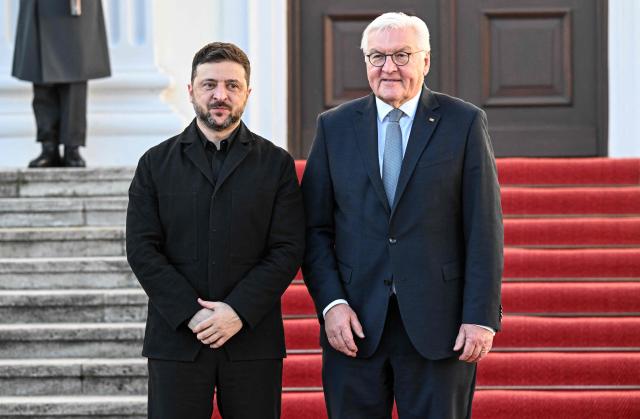 German President Frank-Walter Steinmeier (R) welcomes Ukraine's President Volodymyr Zelensky at the presidential Bellevue Palace in Berlin, Germany, on December 15, 2025. Ukrainian President Volodymyr Zelensky was set to push on with talks in Berlin with US President Donald Trump's envoys on how to end the grinding war with Russia. (Photo by RALF HIRSCHBERGER / AFP)