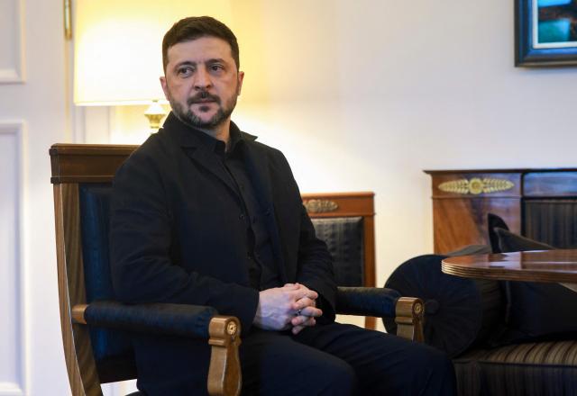 Ukraine's President Volodymyr Zelensky poses ahead talks with the German President at the presidential Bellevue Palace in Berlin, Germany, on December 15, 2025. Ukrainian President Volodymyr Zelensky was set to push on with talks in Berlin with US President Donald Trump's envoys on how to end the grinding war with Russia. (Photo by Clemens BILAN / POOL / AFP)