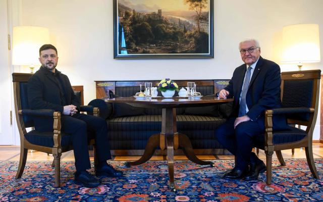 German President Frank-Walter Steinmeier (R) poses with Ukraine's President Volodymyr Zelensky ahead talks at the presidential Bellevue Palace in Berlin, Germany, on December 15, 2025. Ukrainian President Volodymyr Zelensky was set to push on with talks in Berlin with US President Donald Trump's envoys on how to end the grinding war with Russia. (Photo by Clemens BILAN / POOL / AFP)