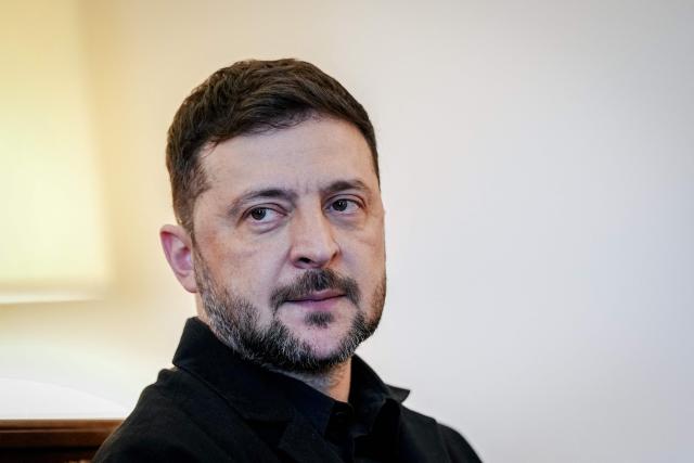 Ukraine's President Volodymyr Zelensky poses ahead talks with the German President at the presidential Bellevue Palace in Berlin, Germany, on December 15, 2025. Ukrainian President Volodymyr Zelensky was set to push on with talks in Berlin with US President Donald Trump's envoys on how to end the grinding war with Russia. (Photo by Kay Nietfeld / POOL / AFP)