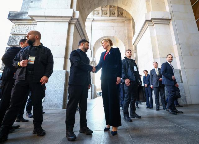 President of the Bundestag (lower house of parliament) Julia Kloeckner welcomes Ukraine's President Volodymyr Zelensky at his arrival at the Reichstag building that houses the Bundestag in Berlin on December 15, 2025. Ukrainian President Volodymyr Zelensky was set to push on with talks in Berlin with US President Donald Trump's envoys on how to end the grinding war with Russia. (Photo by Lisi Niesner / POOL / AFP)