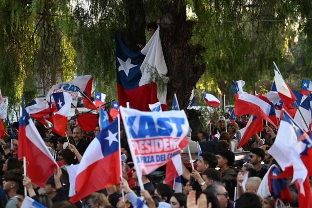 Supporters of Chile's president-elect Jose Antonio Kast celebrate in Santiago, on December 15, the day after the runoff election. Chile elected its most right-wing president in 35 years of democracy on Sunday, with arch-conservative Jose Antonio Kast scoring a thumping victory over his leftist runoff rival. (Photo by EITAN ABRAMOVICH / AFP)