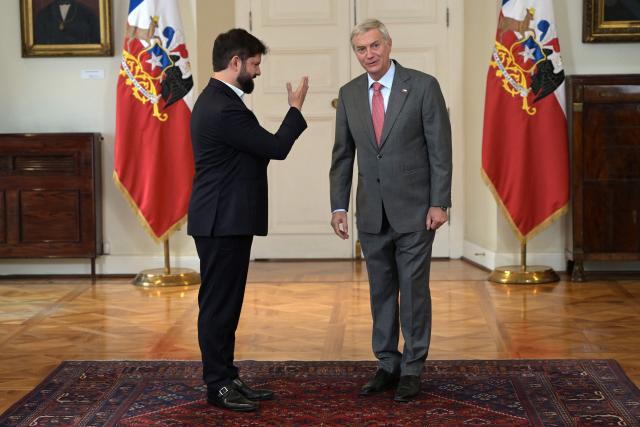 Chile's President Gabriel Boric (L) receives Chile's president-elect Jose Antonio Kast at La Moneda presidential palace in Santiago, on December 15, 2025, the day after the presidential runoff election. Chile elected its most right-wing president in 35 years of democracy on Sunday, with arch-conservative Jose Antonio Kast scoring a thumping victory over his leftist runoff rival. (Photo by Rodrigo ARANGUA / AFP)