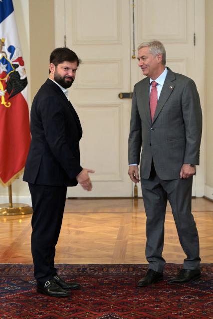Chile's President Gabriel Boric (L) receives Chile's president-elect Jose Antonio Kast at La Moneda presidential palace in Santiago, on December 15, 2025, the day after the presidential runoff election. Chile elected its most right-wing president in 35 years of democracy on Sunday, with arch-conservative Jose Antonio Kast scoring a thumping victory over his leftist runoff rival. (Photo by Rodrigo ARANGUA / AFP)