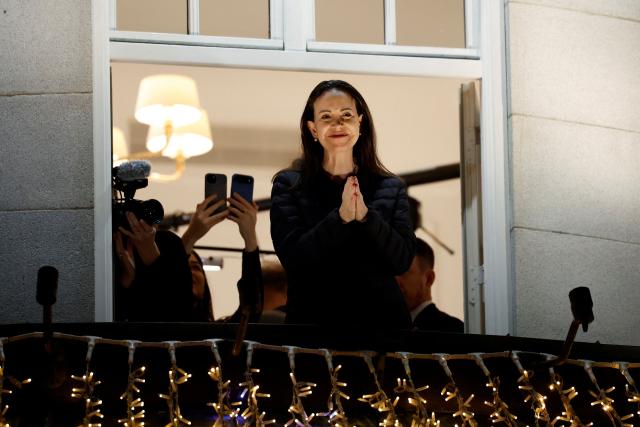 (FILES) Nobel peace laureate Maria Corina Machado gestures from a balcony of the Grand Hotel in Oslo, Norway, in the early hours of December 11, 2025. Venezuelan opposition leader and Nobel Peace Prize laureate Maria Corina Machado suffered a vertebra fracture during her secret journey out of hiding in Venezuela to Norway last week, her spokesperson said on December 15, 2025. (Photo by Odd ANDERSEN / AFP)