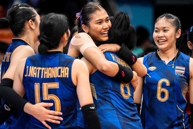 Thailand's KOKRAM Pimpichaya (C) celebrates with teammates after they won the women's volleyball final match of the 33rd Southeast Asian Games (SEA Games) against Vietnam at Huamark Indoor Stadium in Bangkok on December 15, 2025. (Photo by Chanakarn Laosarakham / AFP)