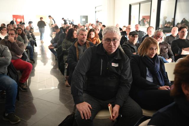 Former HR Director of the Vendome factory Franck Cannorozzi (C) looks on during a meeting about professional retraining options at the Brandt factory, in Vendome, central France on December 15, 2025. The judicial liquidation of the Brandt household appliance group, announced on December 12, 2025 by the Nanterre Economic Court, marks the end of a major name in French industry during the post-war boom years, which has changed hands several times in recent decades. (Photo by JEAN-FRANCOIS MONIER / AFP)