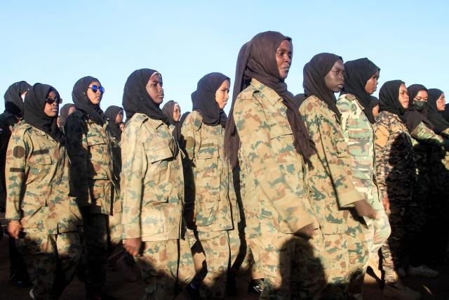 TOPSHOT - Sudanese female military personnel gather after completing a training courses, with the aim of supporting the Sudanese regular army in the Ombada locality west of Omdurman, on December 15, 2025, in the capital Khartoum. The war between the Sudanese Army and Sudan's Rapid Support Forces (RSF) which controls areas of western Sudan, erupted in April 2023, and has caused what the UN has described as the world’s worst humanitarian crisis. (Photo by Ebrahim Hamid / AFP)