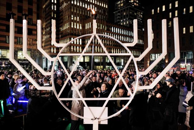 Amsterdam's mayor Femke Halsema lights a candle during a Chanukah celebration in the Zuidas business district, in Amsterdam, on December 15, 2025. (Photo by Ramon van Flymen / ANP / AFP) / Netherlands OUT