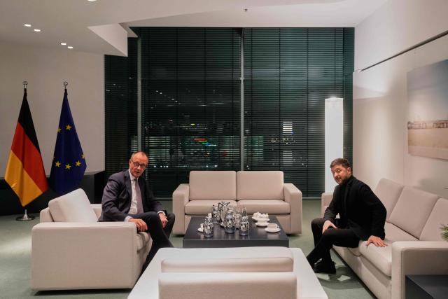 German Chancellor Friedrich Merz and Ukraine's President Volodymyr Zelensky hold talks at the Chancellery in Berlin on December 15, 2025. Ukrainian President Zelensky travelled to Berlin to meet European leaders as well as the US President's envoy, heads of the EU and of the NATO for talks on how to end the grinding war with Russia. (Photo by Markus Schreiber / POOL / AFP)