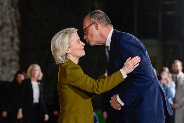 European Commission President Ursula von der Leyen is greeted by German Chancellor Friedrich Merz upon her arrival on December 15, 2025 at the Chancellery in Berlin, Germany, where European leaders as well as the Ukrainian President, US President's envoy, and heads of the NATO meet for talks on how to end the grinding war of Russia with Ukraine. (Photo by John MACDOUGALL / AFP)