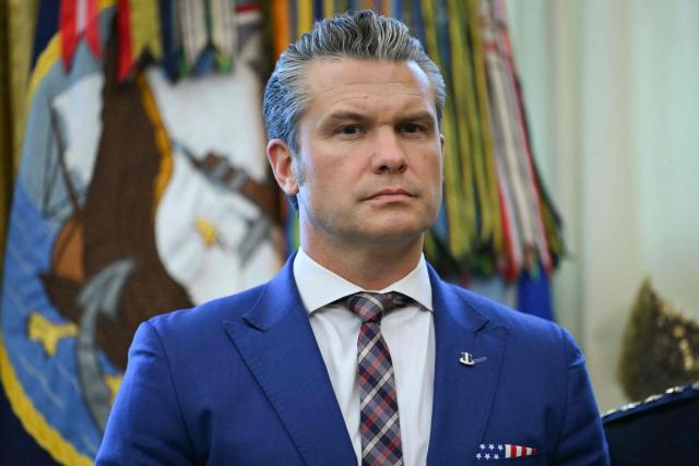 US Defense Secretary Pete Hegseth attends a Mexican Border Defense Medal presentation in the Oval Office of the White House in Washington, DC, on December 15, 2025. (Photo by ANDREW CABALLERO-REYNOLDS / AFP)