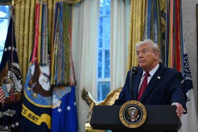 US President Donald Trump speaks during a Mexican Border Defense Medal presentation in the Oval Office of the White House in Washington, DC, on December 15, 2025. (Photo by ANDREW CABALLERO-REYNOLDS / AFP)