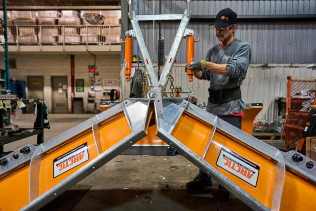 A worker assembles a snow plow at Arctic Snowplows in London, Ontario, on December 10, 2025. For decades, Arctic Snowplows has sold its Canadian-made galvanized steel products to "anywhere there is snow" across the border in the United States, says company boss Mike Schulz. But a year into President Donald Trump's trade war, some of those customers have been lost, with buyers unwilling to stomach higher prices forced by US tariffs on imported steel. "Adding an extra $500 (US$363) on the cost of a $10,000 plow, it's a huge hit," Schulz told AFP, as a heavy snow fell outside the company's factory in London, Ontario, 190 kilometers (120 miles) southwest of Toronto. (Photo by Geoff Robins / AFP)