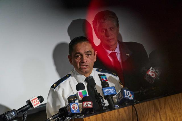Colonel Oscar Perez, chief of the Providence Police Department, speaks during a press conference into the ongoing investigation into the December 13 mass shooting at Brown University, at the Providence Public Safety Complex in Providence, Rhode Island, on December 15, 2025. A gunman remained at large after a weekend mass shooting at elite Brown University left two dead and nine wounded, with US authorities releasing new footage of a masked "person of interest" captured on surveillance cameras. The shooting took place Saturday in a building where exams were underway on the Ivy League campus in Providence, Rhode Island when a man with a rifle burst in and opened fire before fleeing. (Photo by Bing Guan / AFP)