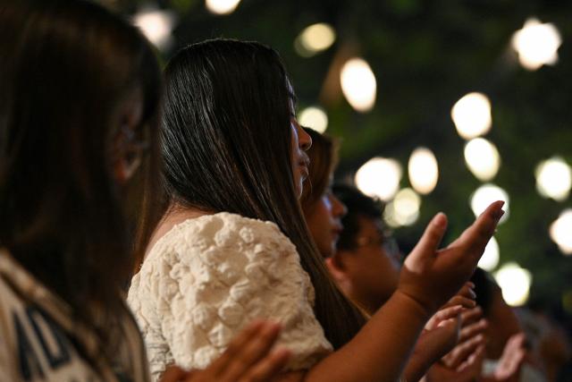 Catholic faithfuls attend the first of nine dawn masses, known as "Misa de Gallo", at a church in Las Pinas, suburban Manila on December 16, 2025, to signal the official start of the Christmas season. (Photo by Ted ALJIBE / AFP)