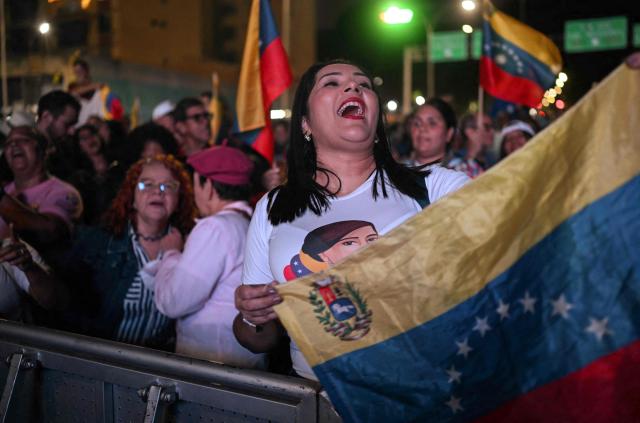 A supporter of Venezuela's President Nicolas Maduro shouts slogans during a rally demanding peace in Caracas on December 15, 2025. The Caribbean nation of Trinidad and Tobago said on December 15, 2025, it had authorized US military aircraft to use its airports, amid growing fears Washington may be preparing an attack on nearby Venezuela. (Photo by Juan BARRETO / AFP)