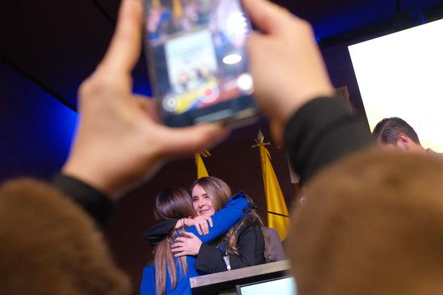 Colombian senator Paloma Valencia (R) celebrates after being elected presidential candidate for the Democratic Center party in Bogota on December 15, 2025. Colombia's main opposition party chose as its candidate to succeed leftist President Gustavo Petro in 2026 a senator aligned with Donald Trump who backs his pressure on Venezuelan President Nicolas Maduro. (Photo by Mariano Vimos / AFP)