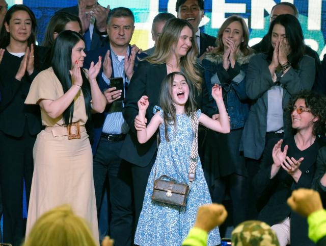 Colombian senator Paloma Valencia (C) celebrates with her family and supporters after being elected presidential candidate for the Democratic Center party in Bogota on December 15, 2025. Colombia's main opposition party chose as its candidate to succeed leftist President Gustavo Petro in 2026 a senator aligned with Donald Trump who backs his pressure on Venezuelan President Nicolas Maduro. (Photo by Mariano Vimos / AFP)