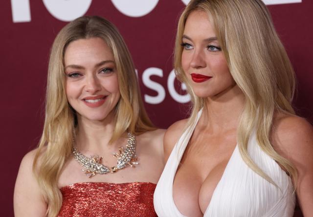 US actresses Amanda Seyfried (L) and Sydney Sweeney attend the LA premiere of Lionsgate's "The Housemaid" at the TCL Chinese theatre in Los Angeles, on December 15, 2025. (Photo by Patrick T. Fallon / AFP)