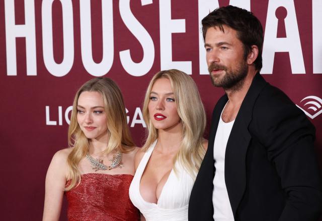 (L/R) US actors Amanda Seyfried, Sydney Sweeney and Brandon Sklenar attend the LA premiere of Lionsgate's "The Housemaid" at the TCL Chinese theatre in Los Angeles, on December 15, 2025. (Photo by Patrick T. Fallon / AFP)