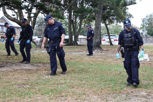 The police search for evidence around the area where the Bondi Beach shooting took place in Sydney on December 16, 2025. Australia's leaders have agreed to toughen gun laws after attackers killed 15 people at a Jewish festival on Bondi Beach, the worst mass shooting in decades decried as antisemitic "terrorism" by authorities. (Photo by DAVID GRAY / AFP)