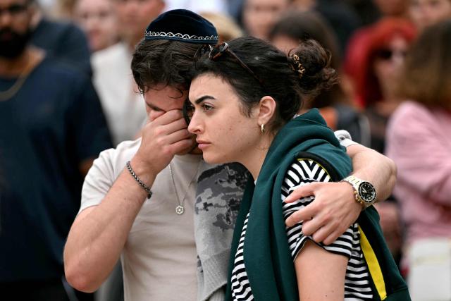 Mourners gather at a tribute at the Bondi Pavilion in memory of the victims of a shooting at Bondi Beach, in Sydney on December 16, 2025. Australia's leaders have agreed to toughen gun laws after attackers killed 15 people at a Jewish festival on Bondi Beach, the worst mass shooting in decades decried as antisemitic "terrorism" by authorities. (Photo by Saeed KHAN / AFP)