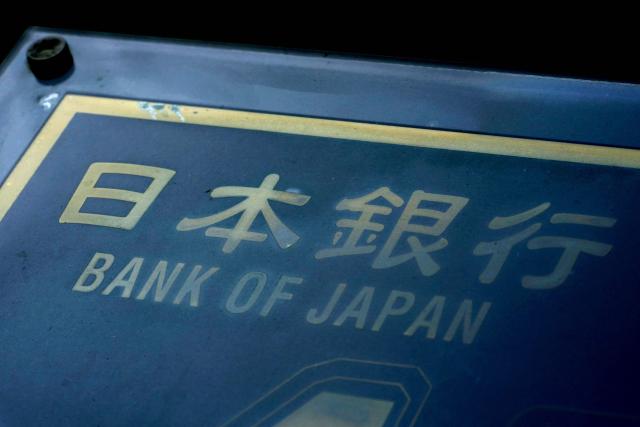 The name of the Bank of Japan written on a notice board directing visitors to the Bank of Japan Head Office is seen in Tokyo on December 16, 2025. The Bank of Japan is expected to hike interest rates on December 19, for the first time since January, pushing them to their highest level in 30 years and potentially exacerbating turmoil in debt markets. (Photo by Kazuhiro NOGI / AFP)