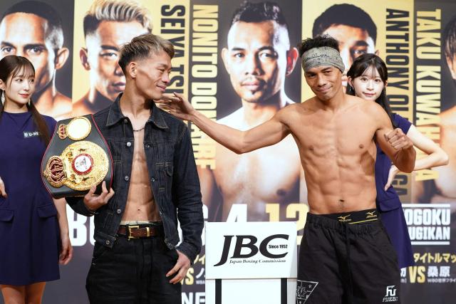 Japan's Seiya Tsutsumi (front, L) and Philippines' Nonito Donaire (front, R) pose for photos at an official weigh-in in Tokyo on December 16, 2025, ahead of their WBA Bantamweight title match on December 17 at Tokyo's Kokugikan. (Photo by Kazuhiro NOGI / AFP)