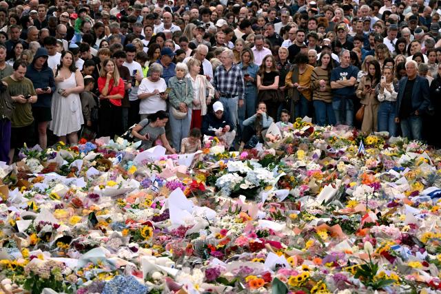 Mourners gather at a tribute at the Bondi Pavilion in memory of the victims of a shooting at Bondi Beach, in Sydney on December 16, 2025. Australia's leaders have agreed to toughen gun laws after attackers killed 15 people at a Jewish festival on Bondi Beach, the worst mass shooting in decades decried as antisemitic "terrorism" by authorities. (Photo by Saeed KHAN / AFP)