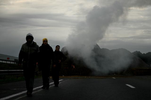 French farmers block the A63 motorway at the Cestas interchange in Gironde, south-western France on December 16, 2025, as part of nationwide action by farmers to protest against the government's mandatory culling protocol for cattle herds affected by lumpy skin disease (dermatose nodulaire contagieuse), a viral disease first detected in France in June 2025 that has led to the slaughter of over 3,000 cattle across more than 110 outbreaks nationwide, and against an EU trade deal with Mercosur countries. (Photo by Philippe LOPEZ / AFP)
