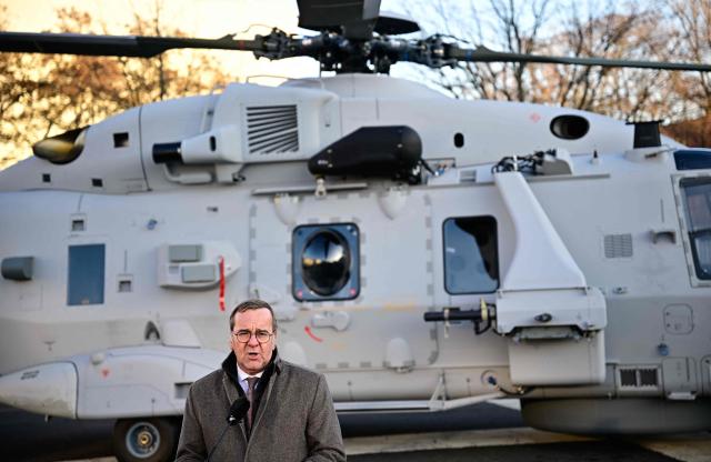 German Defence Minister Boris Pistorius (R) gives a statement in front of a Sea Tiger Sea Tiger shipboard helicopter NH-90 MRFH after it landed in the courtyard of the Defence ministry prior to a handing over ceremony of the first of these helicopters to the German Navy, on December 16, 2025 in Berlin. The Sea Tiger is a high-performance and versatile shipborne helicopter, developed for national and alliance defense. A total of 30 NH-90 MRFH Sea Tiger helicopters will be stationed with Naval Air Wing 5 in Nordholz, Lower Saxony. (Photo by Tobias SCHWARZ / AFP)