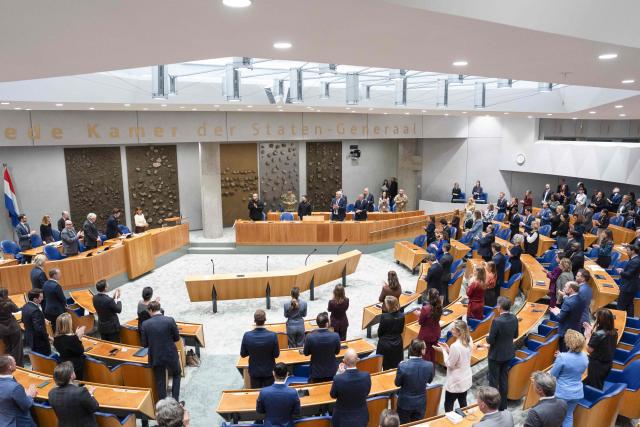 Attendees stand at The Netherlands' House of Representatives with Secretary of the National Security and Defense Council of Ukraine Rustem Umerov (C), Ukrainian President Volodymyr Zelensky, Ukrainian Foreign Minister Andrii Sybiha in The Hague, on December 16, 2025. Zelensky is in The Hague for a conference discussing compensations for Ukraine for the consequences of Russian aggression. (Photo by Jeroen Jumelet / ANP / AFP) / Netherlands OUT