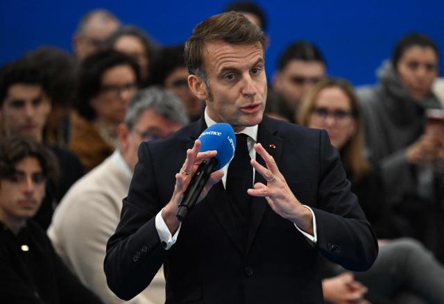 France's President Emmanuel Macron addresses the audience during a meeting with some readers of the daily newspaper "La Provence" as part of his visit to Marseille, southern France, on December 16, 2025. (Photo by Miguel MEDINA / POOL / AFP)