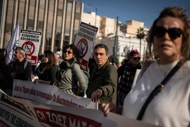 Greek public sector workers take part in a demonstration during a 24-hour strike against the 2026 budget undergoing government review, in Athens on December 16, 2025. (Photo by Aris MESSINIS / AFP)