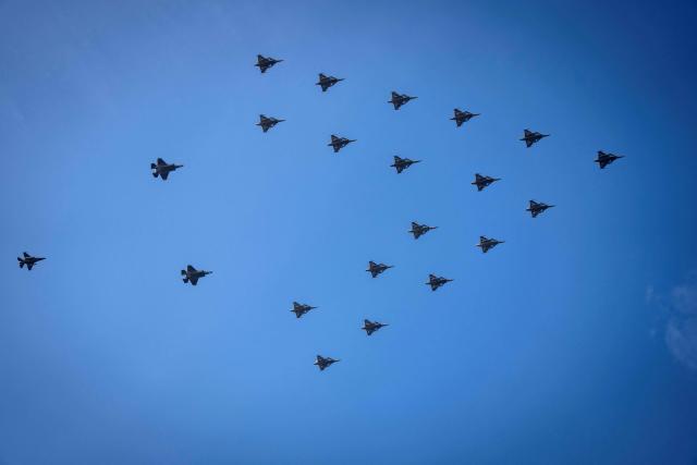 Fighter jets fly in Christmas tree formation over Copenhagen and the Oeresund region on December 16, 2025. Swedish Gripen fighter jets as well as Danish F-16 and F-35 fighter jets participate in Tuesday's flight, according to the Ministry of Defence. The Christmas tree formation of fighter jets is a Swedish tradition that has been extended to several Nordic countries with Sweden's entry into NATO. (Photo by Sebastian Elias Uth / Ritzau Scanpix / AFP) / Denmark OUT