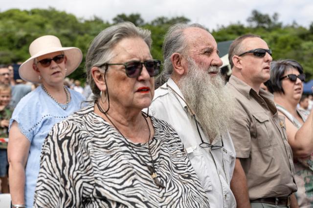 Attendees sing hymns during a church service as Afrikaners gather to celebrate the Day of the Vow (Geloftedag) at the Voortrekker Monument in Pretoria on December 16, 2025. The Day of the Vow (Geloftedag), which has since been renamed Reconciliation Day, is celebrated by traditional Afrikaners as the day they defeated the Zulu's at the Battle of Blood River, in KwaZulu Natal, on December 16, 1838. (Photo by Wikus de Wet / AFP)