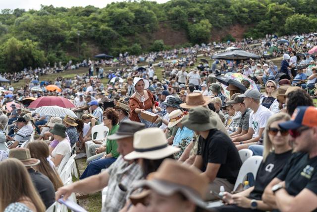 A woman (C) dressed in traditional Voortrekker attire collects offerings during a church service as Afrikaners gather to celebrate the Day of the Vow (Geloftedag) at the Voortrekker Monument in Pretoria on December 16, 2025. The Day of the Vow (Geloftedag), which has since been renamed Reconciliation Day, is celebrated by traditional Afrikaners as the day they defeated the Zulu's at the Battle of Blood River, in KwaZulu Natal, on December 16, 1838. (Photo by Wikus de Wet / AFP)