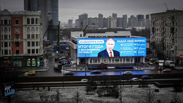 This photograph shows an advertising screen displaying an image of Russian President Vladimir Putin in western Moscow, on December 16, 2025, couple days ahead Putin's annual end-of-year press conference. (Photo by Alexander NEMENOV / AFP)