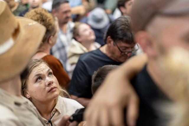 An attendee looks up at the light beam that shines through the roof that will later shine on the cenotaph as Afrikaners gather to celebrate the Day of the Vow (Geloftedag) at the Voortrekker Monument in Pretoria on December 16, 2025. The Day of the Vow (Geloftedag), which has since been renamed Reconciliation Day, is celebrated by traditional Afrikaners as the day they defeated the Zulu's at the Battle of Blood River, in KwaZulu Natal, on December 16, 1838. (Photo by Wikus de Wet / AFP)